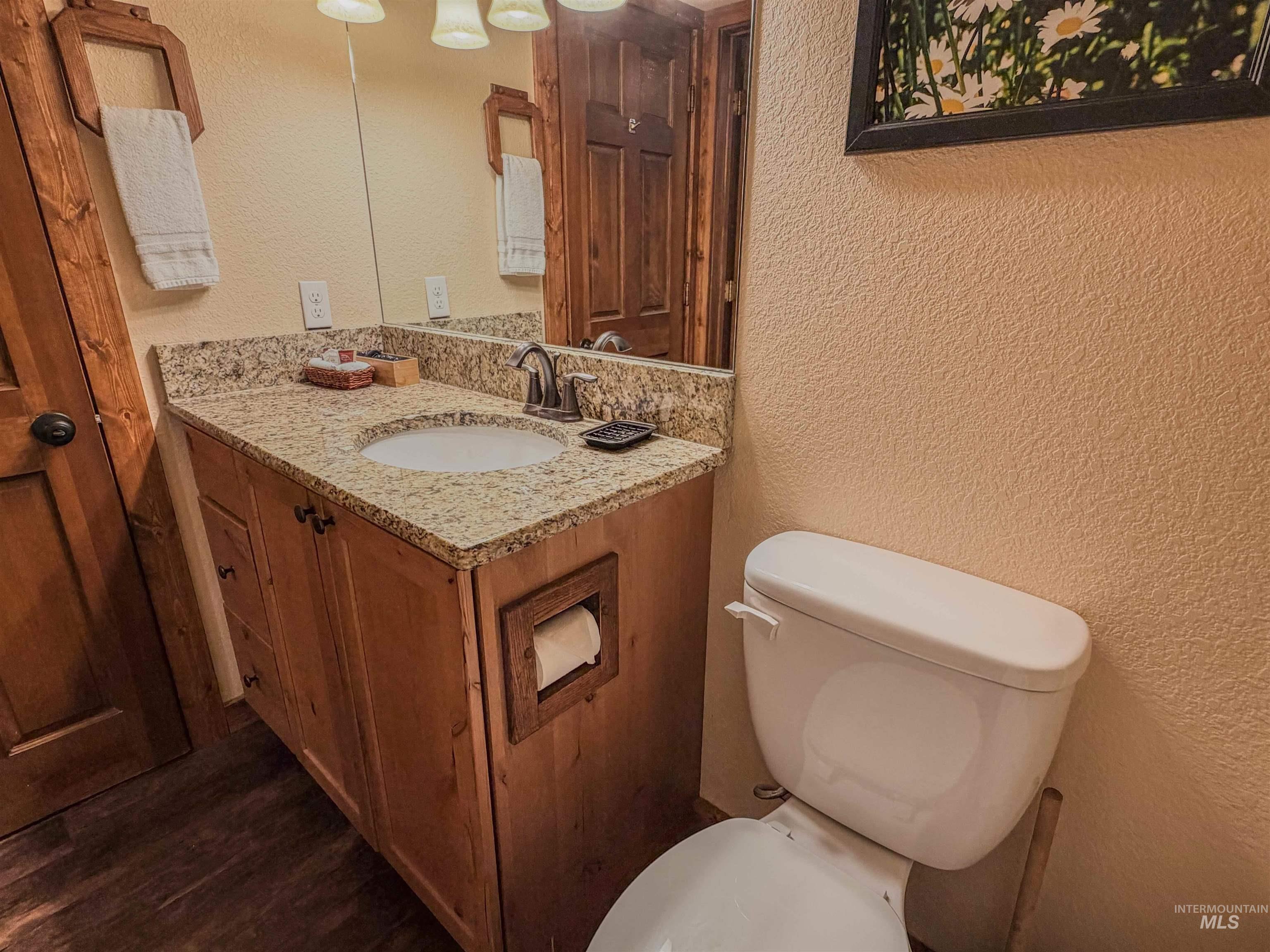 1607 Davis Avenue, Unit C6 McCall, ID 83638 - Photo 16 of 30 Half bathroom featuring a textured wall and vanity