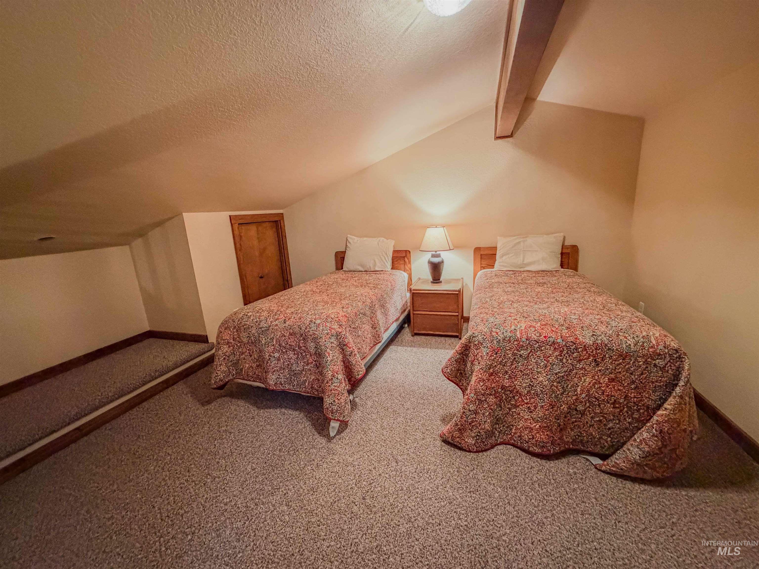 1607 Davis Avenue, Unit C6 McCall, ID 83638 - Photo 9 of 30 Bedroom with a textured ceiling and light colored carpet