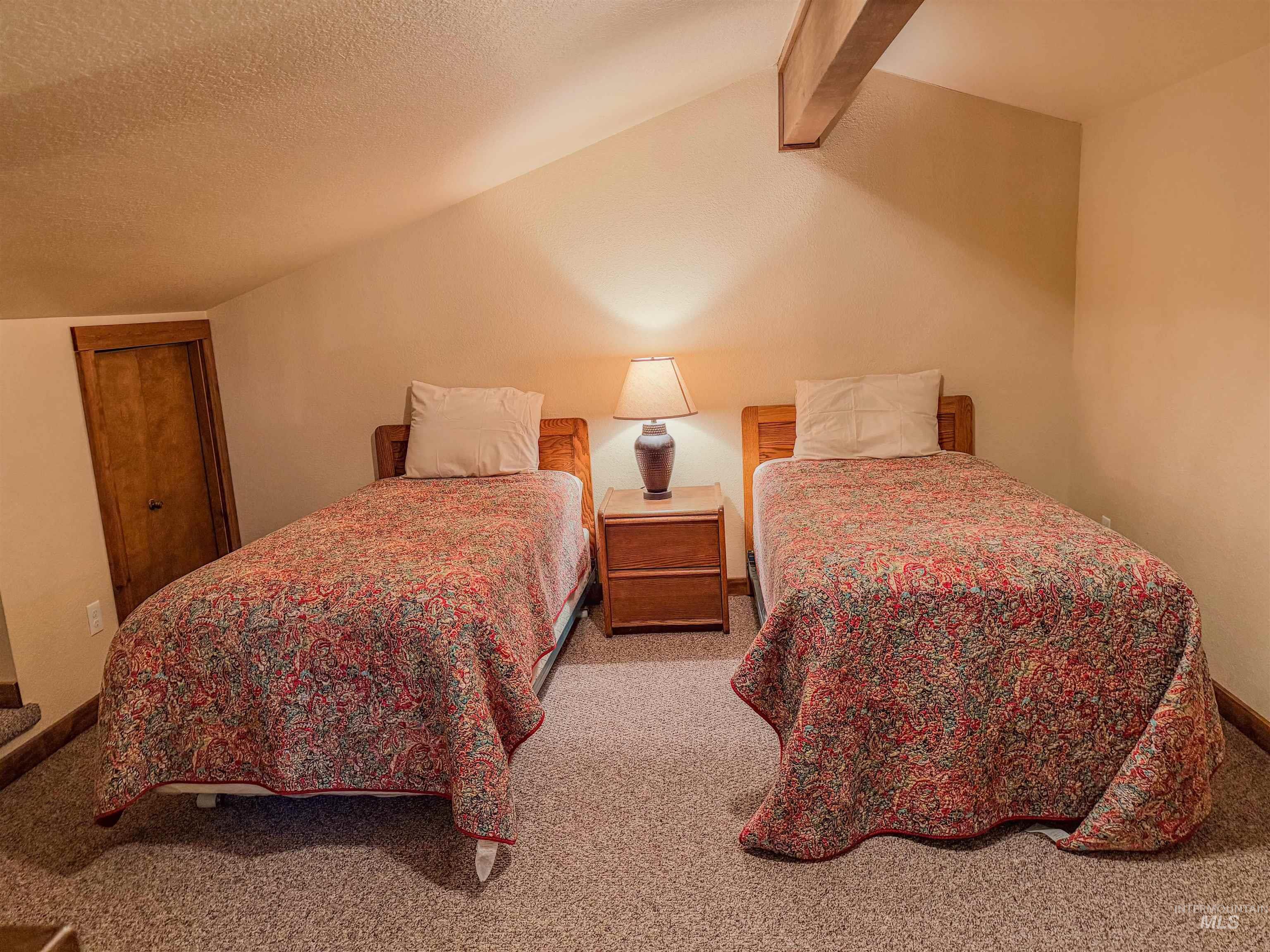 1607 Davis Avenue, Unit C6 McCall, ID 83638 - Photo 10 of 30 Carpeted bedroom featuring a textured ceiling and vaulted ceiling
