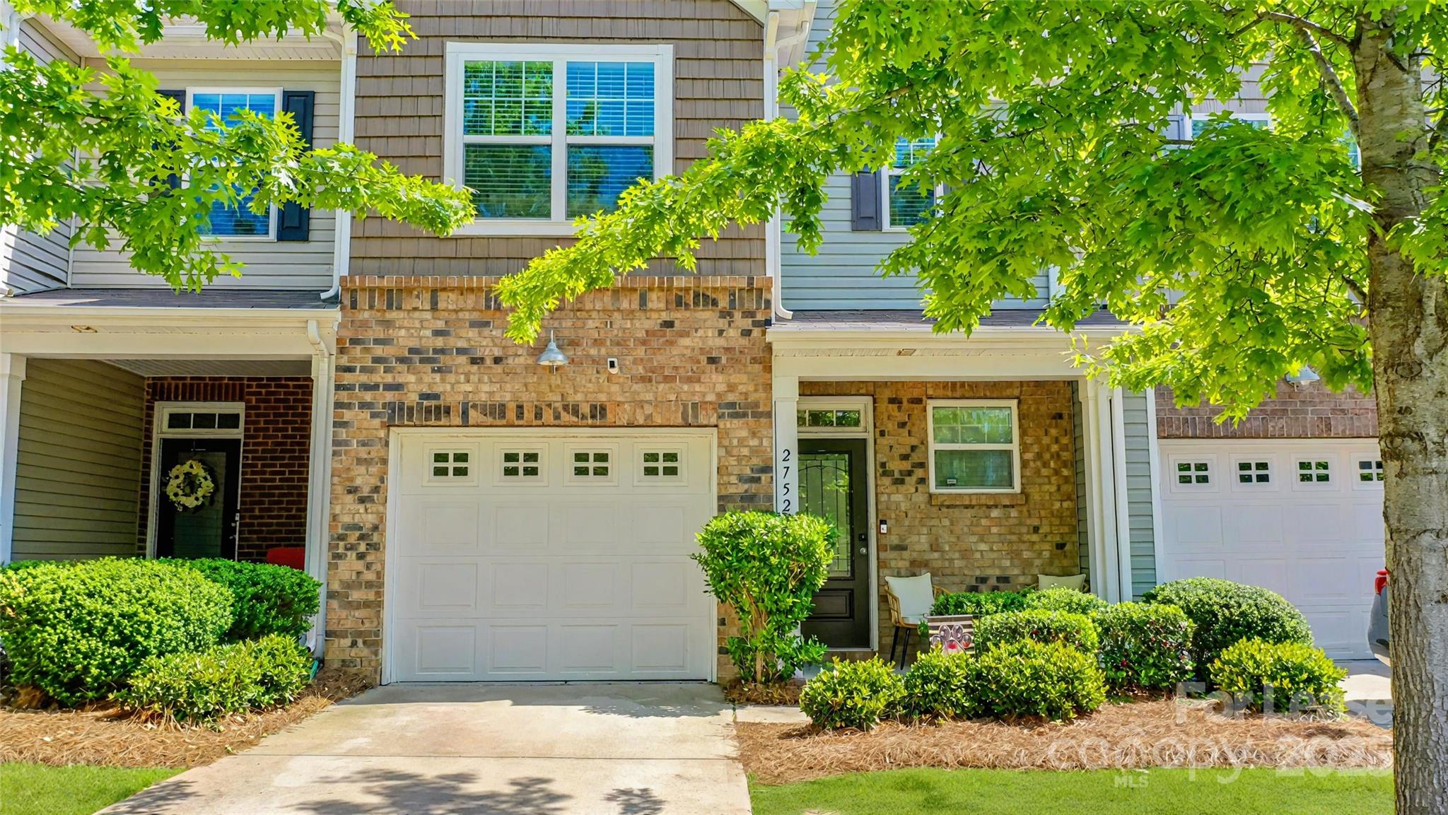2752 Sawbridge Lane Gastonia, NC 28056 - Photo 1 of 25 a front view of a house with a yard and potted plants