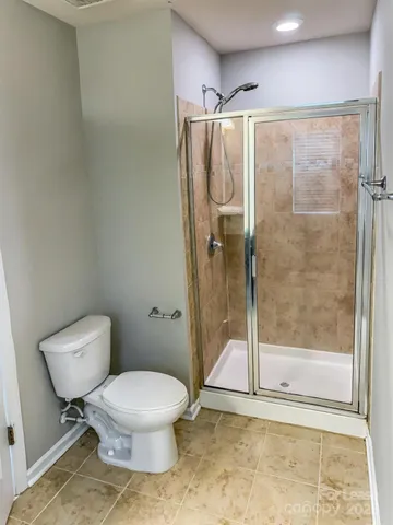 a bathroom with a toilet and a shower