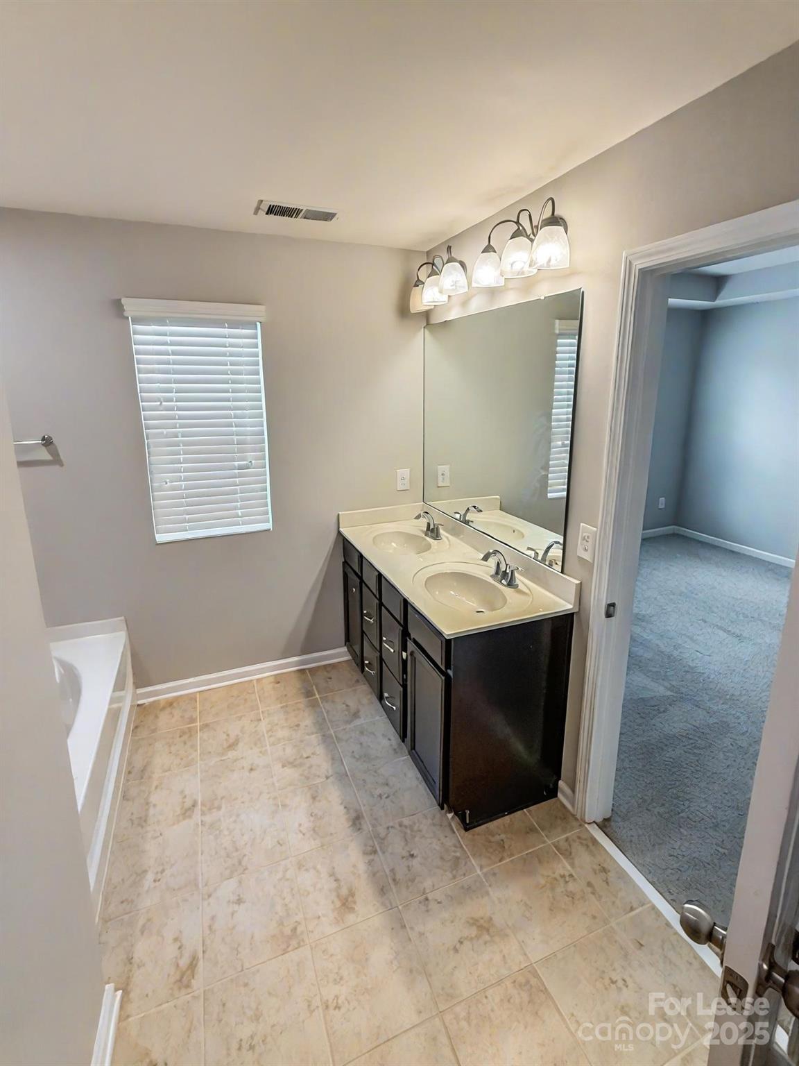 2752 Sawbridge Lane Gastonia, NC 28056 - Photo 15 of 25 a bathroom with a sink and a mirror