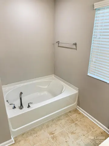 a bathroom with a bathtub and shower