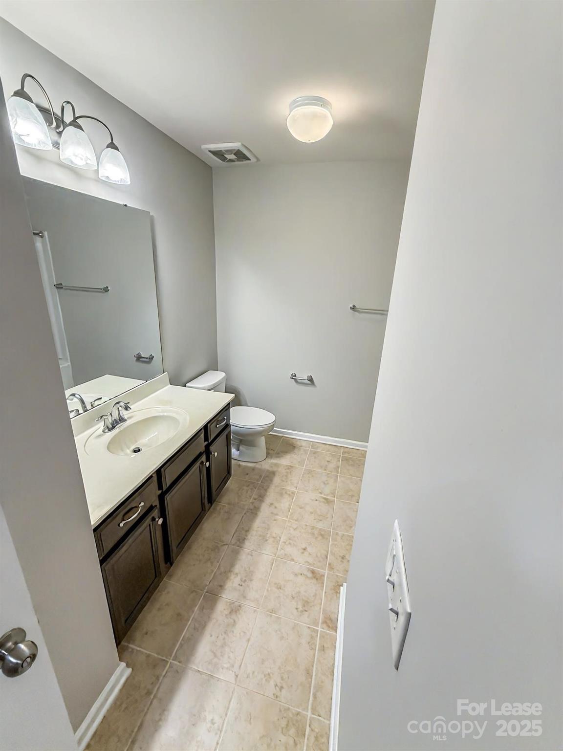 2752 Sawbridge Lane Gastonia, NC 28056 - Photo 19 of 25 a bathroom with a sink a toilet and mirror