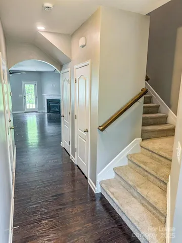 a view of entryway and hall with wooden floor
