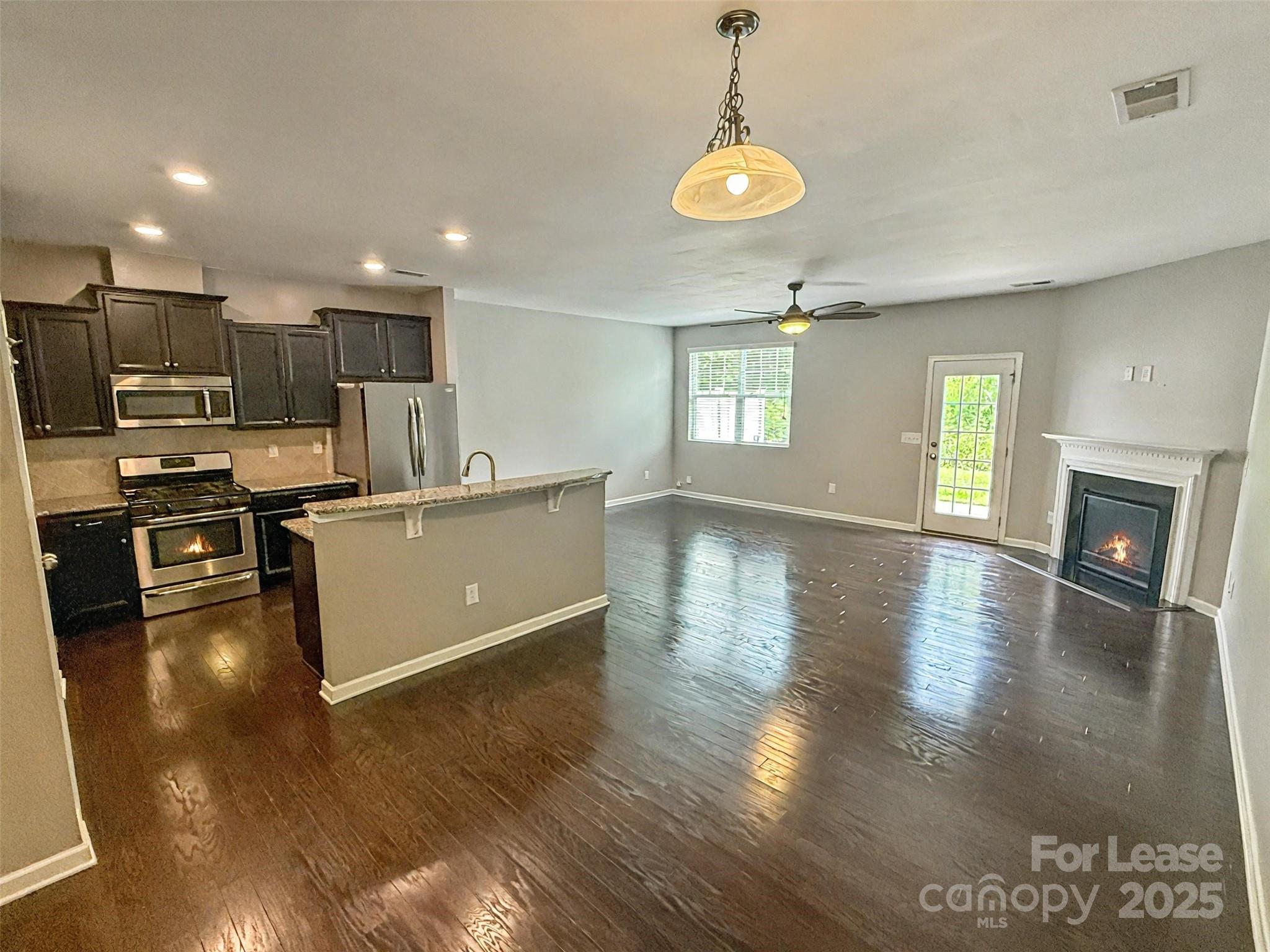 2752 Sawbridge Lane Gastonia, NC 28056 - Photo 6 of 25 a view of a kitchen with furniture and wooden floor