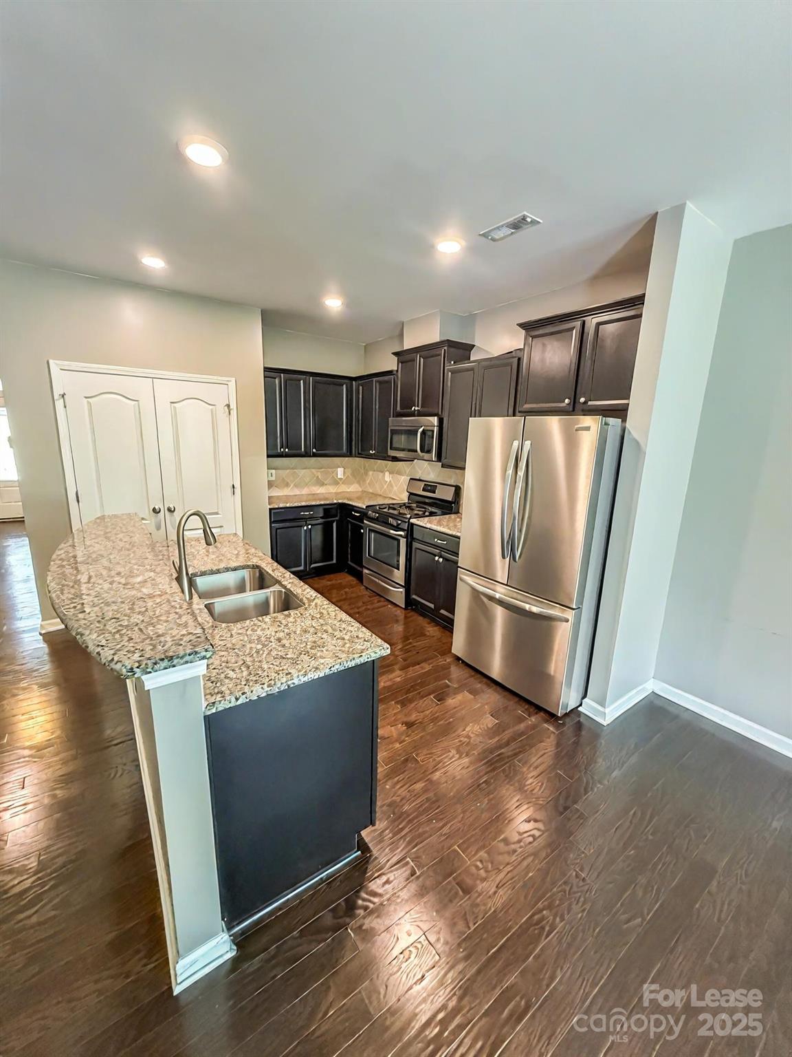 2752 Sawbridge Lane Gastonia, NC 28056 - Photo 9 of 25 a kitchen with stainless steel appliances granite countertop a refrigerator a stove a sink and a refrigerator
