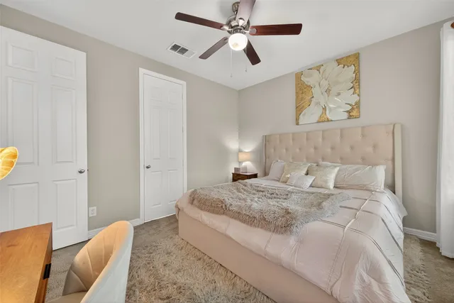 a bedroom with a bed and a painting on the wall