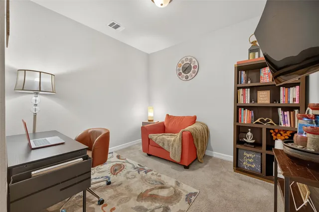 a bedroom with furniture and a book shelf