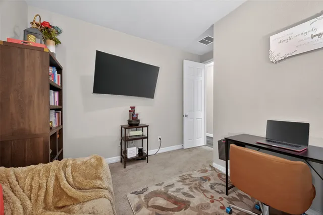 a bedroom with a bed and a television