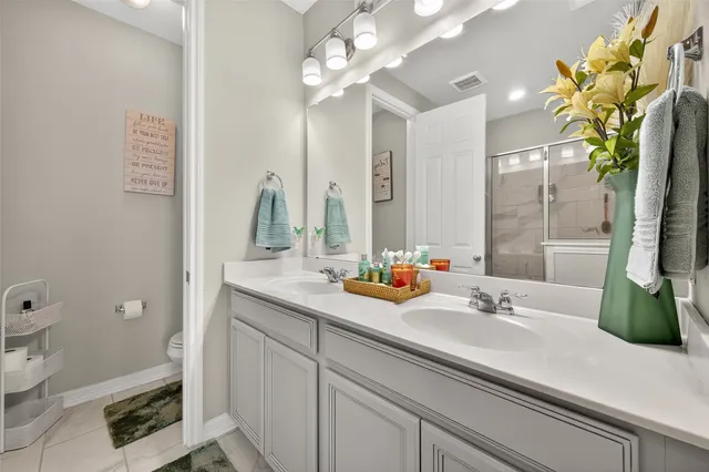 a bathroom with a sink a toilet and mirror