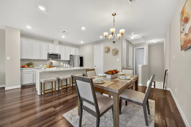 a view of kitchen with refrigerator dining table and chairs
