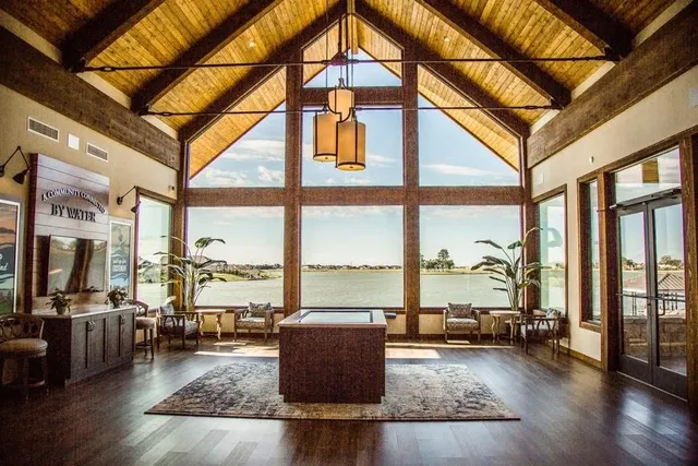 a living room with furniture and floor to ceiling windows