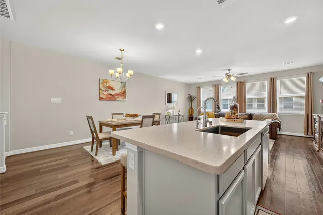 a large kitchen with a table and chairs