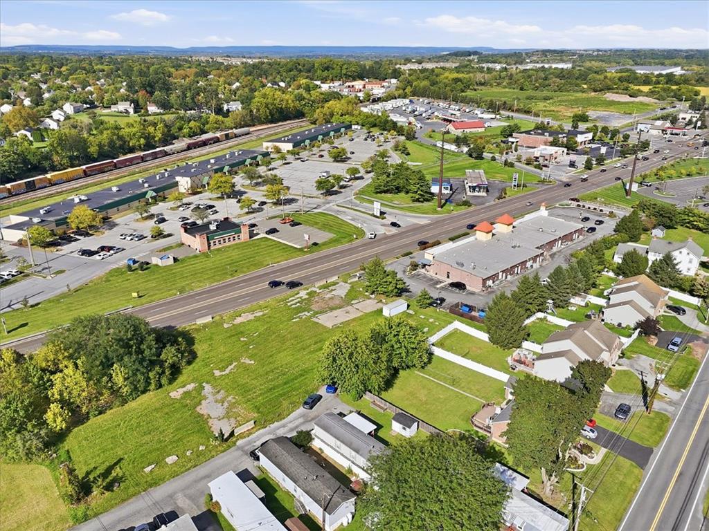 6129 Memorial Road Allentown, PA 18104 - Photo 45 of 46 A high-altitude perspective showcases a verdant landscape bordering a bustling suburban thoroughfare.