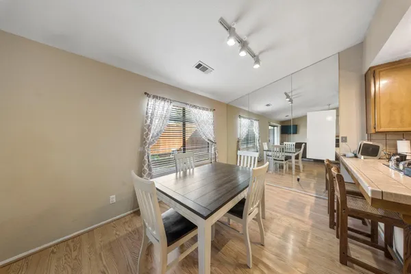 a kitchen that has a sink a table and chairs in it