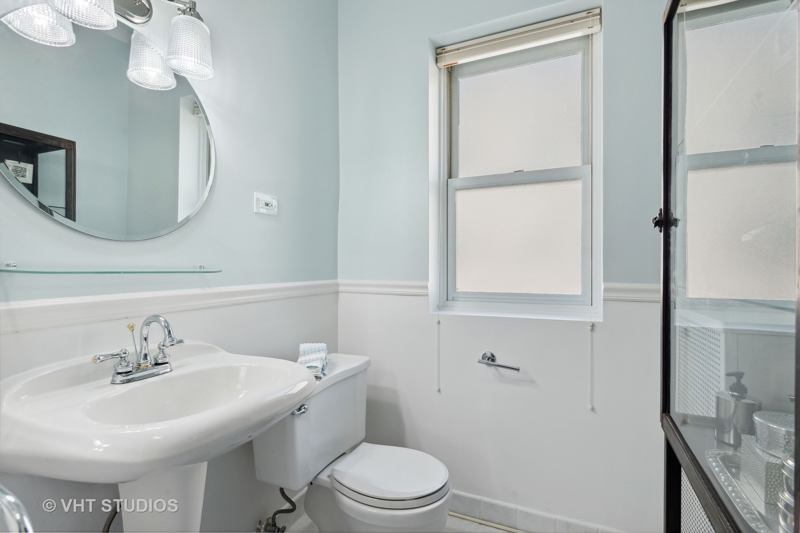 3755 North Pine Grove Avenue, Unit 2 Chicago, IL 60613 - Photo 14 of 17 a bathroom with a sink a toilet and mirror