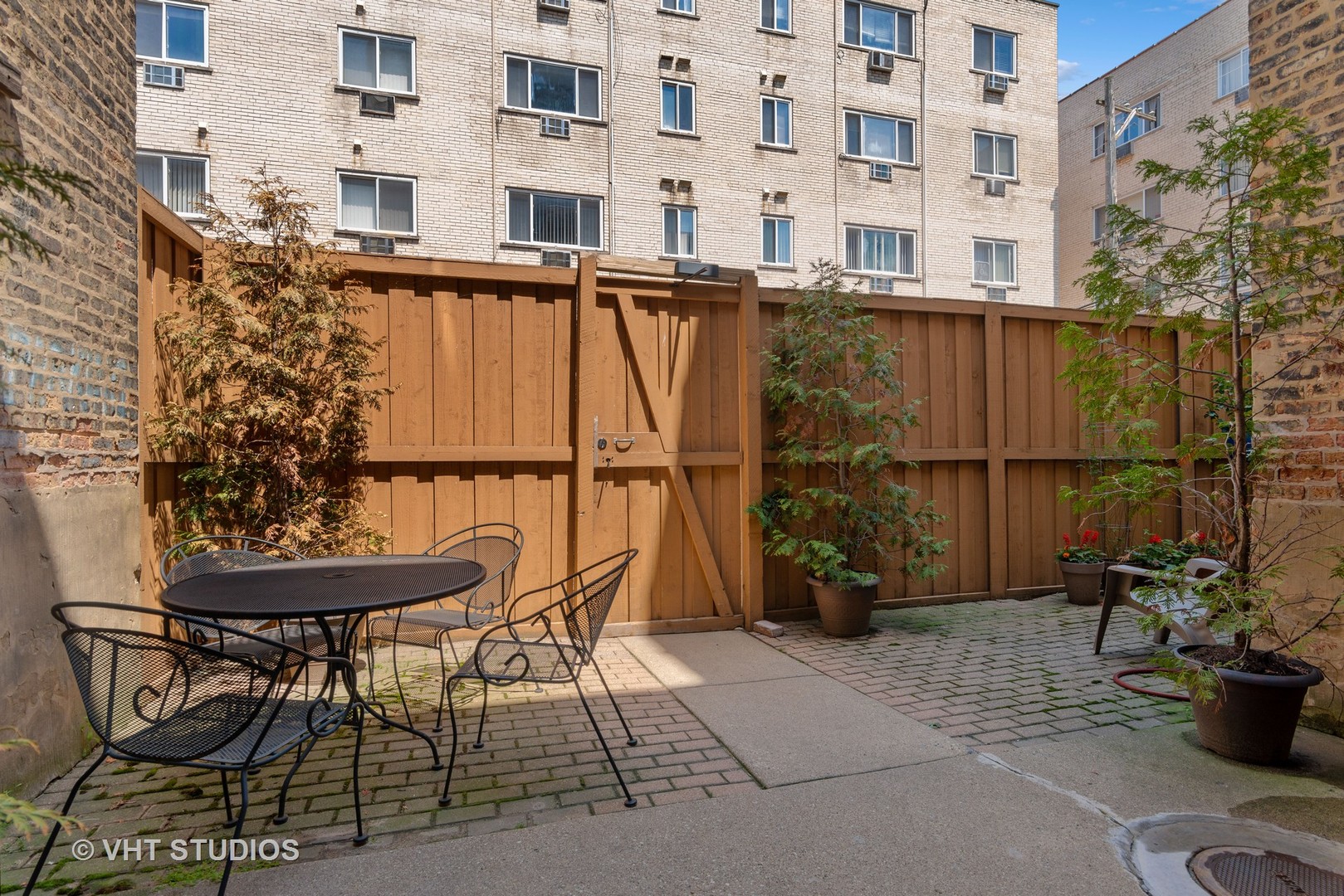 3755 North Pine Grove Avenue, Unit 2 Chicago, IL 60613 - Photo 17 of 17 a balcony with table and chairs