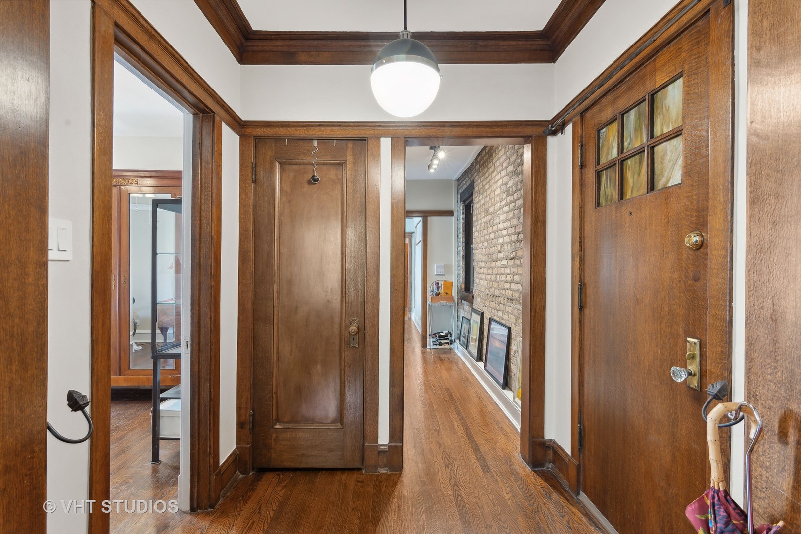 3755 North Pine Grove Avenue, Unit 2 Chicago, IL 60613 - Photo 3 of 17 a view of a hallway with wooden floor and staircase