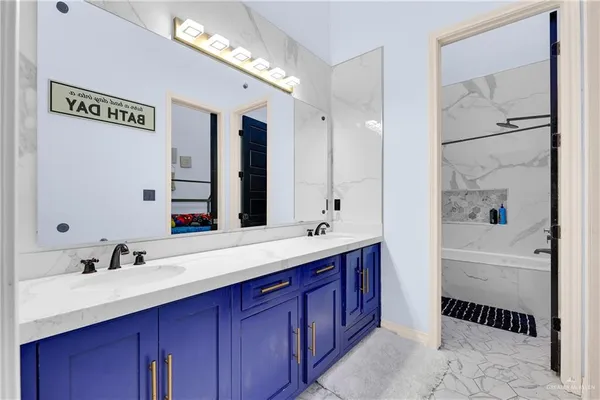 a bathroom with a bathtub shower sink and mirror