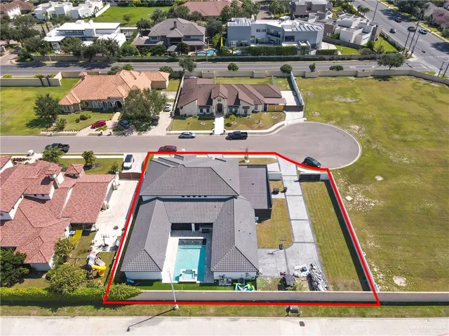 an aerial view of a house with swimming pool and ocean view
