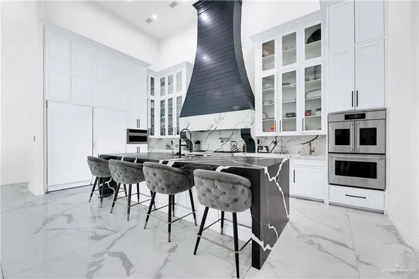 a kitchen with a table chairs sink and cabinets