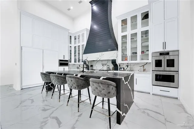 a kitchen with a table chairs sink and cabinets