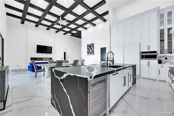 a open kitchen with stainless steel appliances granite countertop a sink counter space cabinets and a sink