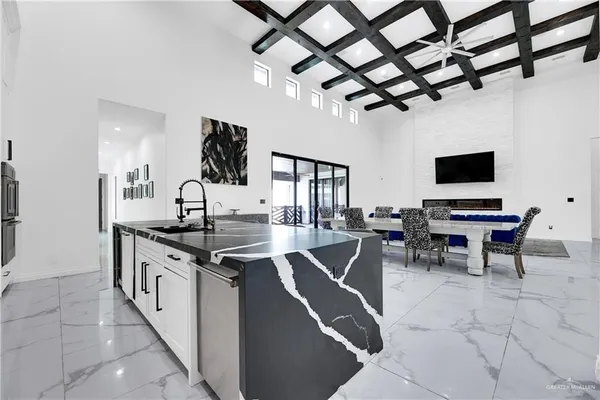 a kitchen with stainless steel appliances granite countertop a sink a stove and a refrigerator