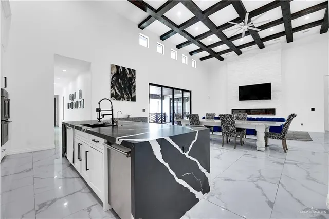 a kitchen with stainless steel appliances granite countertop a sink a stove and a refrigerator