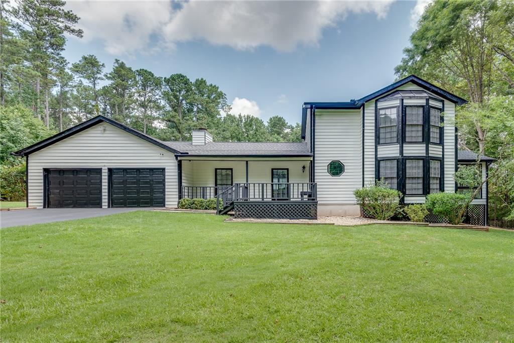 335 Pony Tail Road Alpharetta, GA 30004 - Photo 1 of 1 a front view of a house with a yard and garage