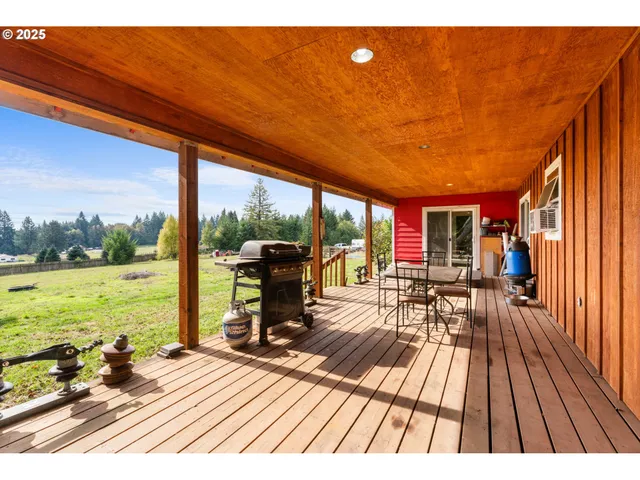 a view of a patio with lawn chairs floor to ceiling window and an outdoor space