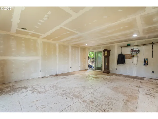 a view of backyard with wooden floor and fence