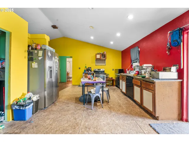 a living room with stainless steel appliances kitchen island granite countertop furniture and a flat screen tv