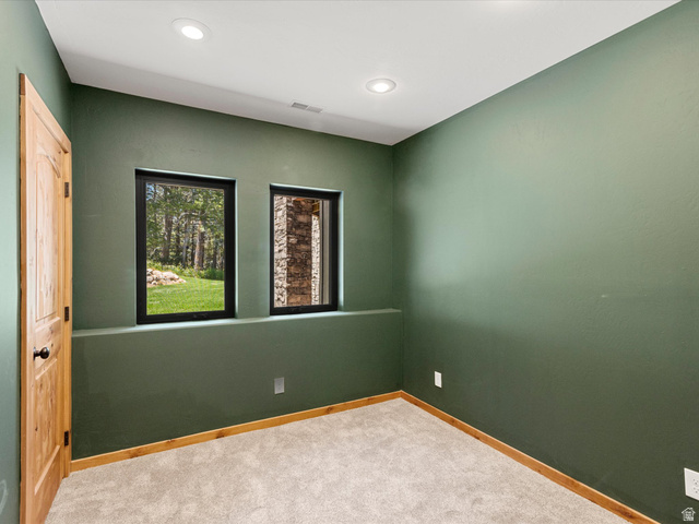 1225 Old Oregon Road Soda Springs, ID 83276 - Photo 27 of 67 Interior room featuring green painted walls, recessed ceiling lighting, and light-toned carpet flooring