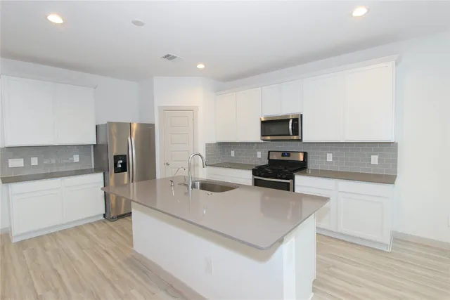 a kitchen with a refrigerator stove and microwave