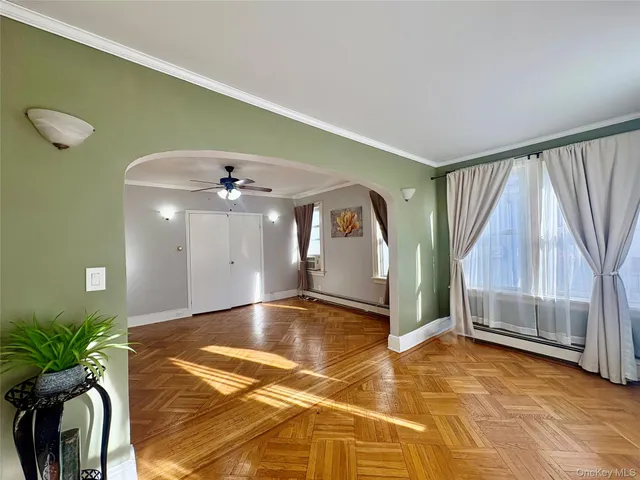 a view of an entryway with a floor to ceiling window and a ceiling fan