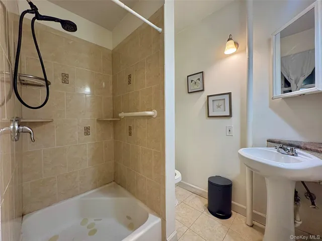 a bathroom with a bath tub and shower