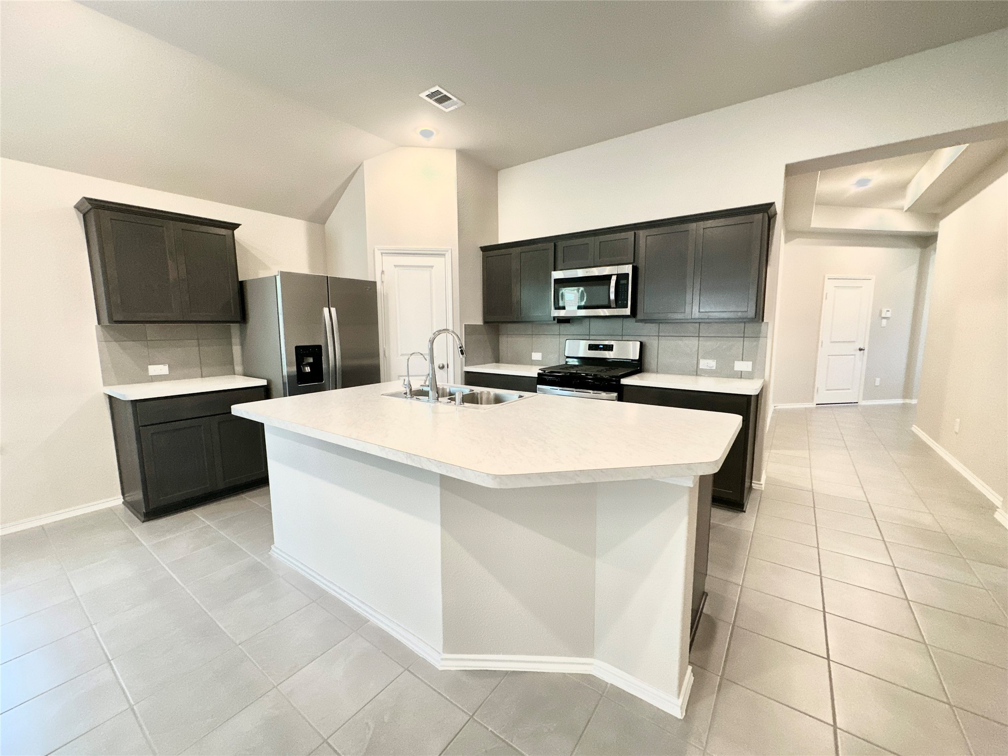 3308 Scarlet Tupelo Way Spring, TX 77386 - Photo 7 of 23 a kitchen with a sink a counter top space appliances and cabinets