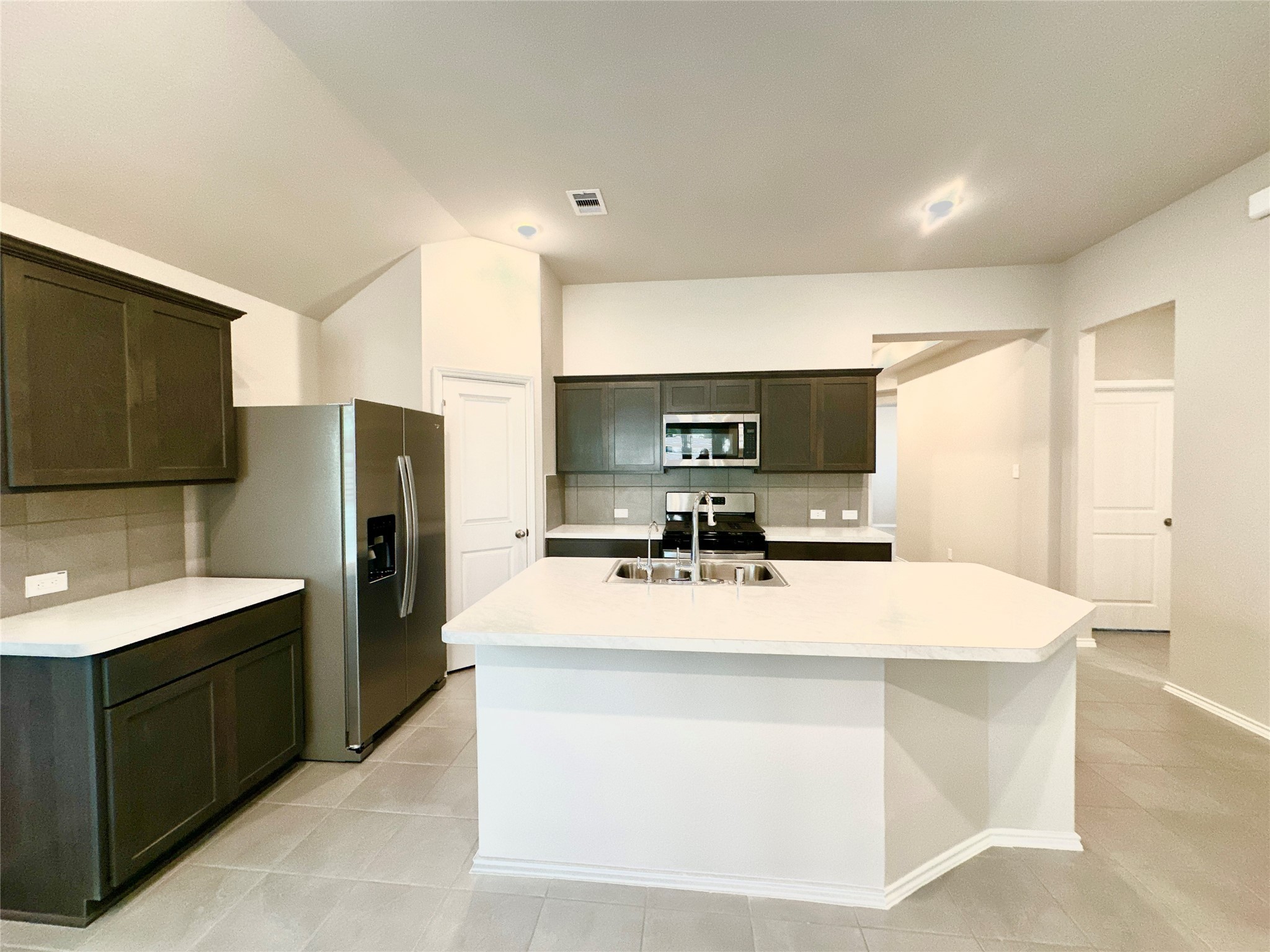3308 Scarlet Tupelo Way Spring, TX 77386 - Photo 8 of 23 a kitchen with stainless steel appliances a sink and a refrigerator