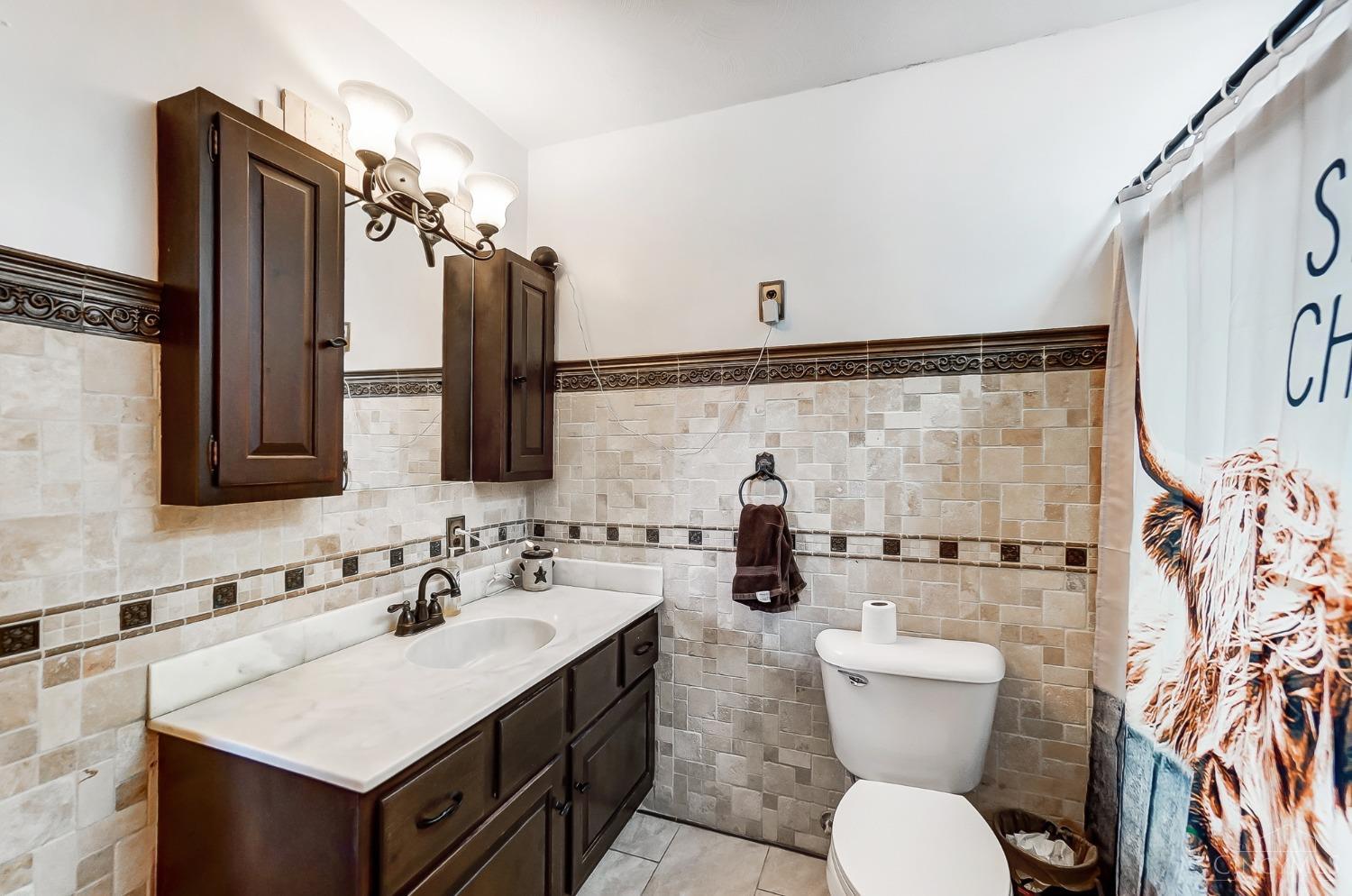 2711 Lebanon Road Clarksville, OH 45113 - Photo 16 of 48 The large first floor bathroom features a tub shower, tiled flooring and additional counter space.