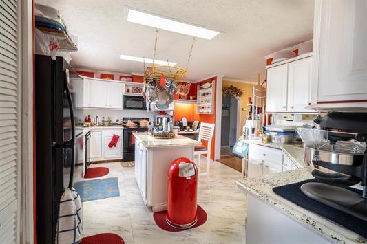 183 Smith Farm Road Northeast Check, VA 24072 - Photo 18 of 23 a kitchen with stainless steel appliances granite countertop a refrigerator sink stove and cabinets