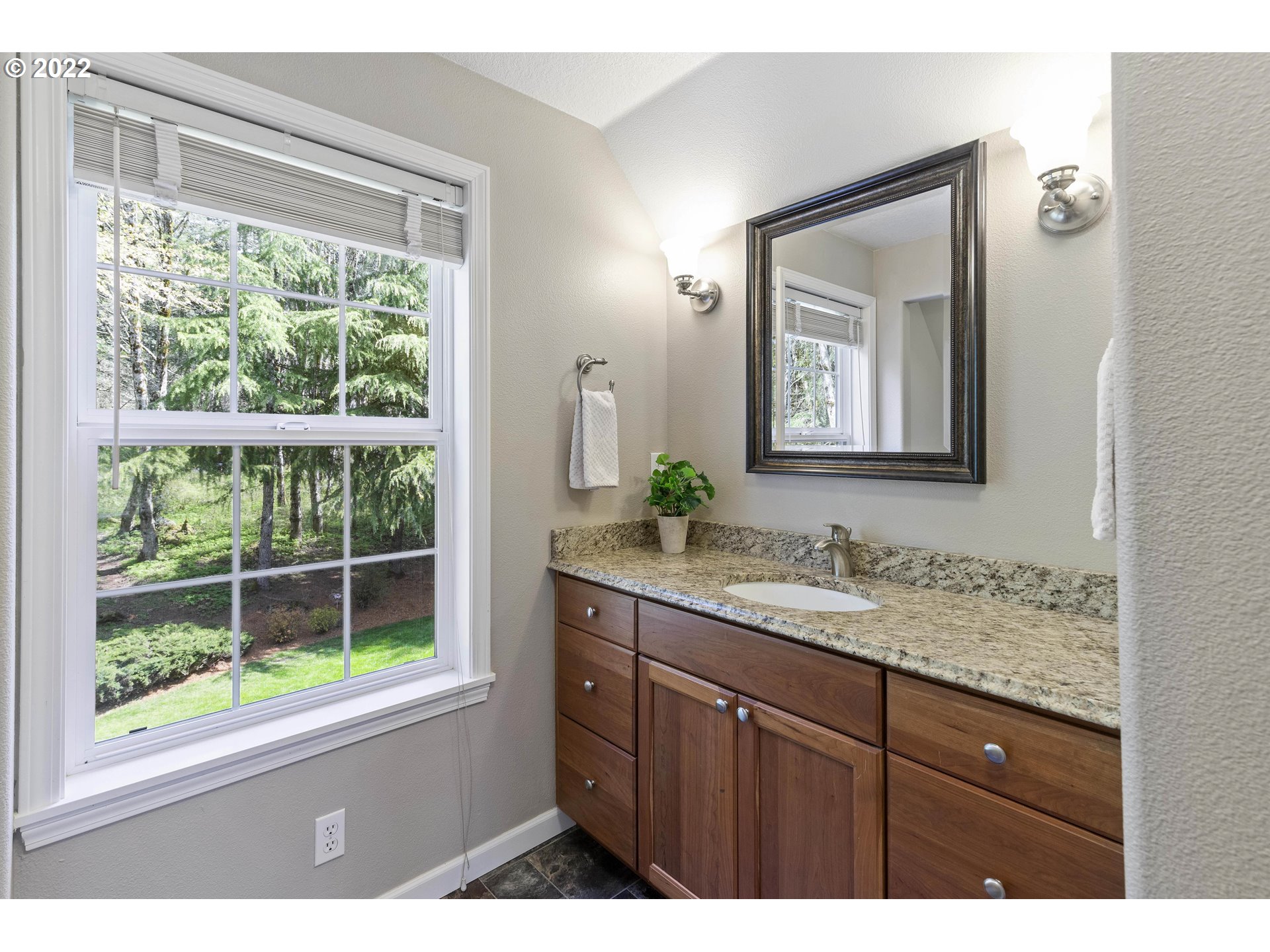 28501 Northeast 67th Street Camas, WA 98607 - Photo 28 of 32 a bathroom with a granite countertop sink a mirror and a window