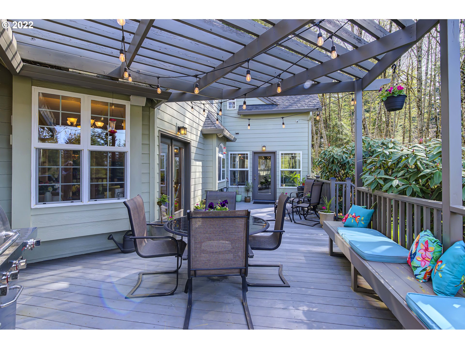 28501 Northeast 67th Street Camas, WA 98607 - Photo 30 of 32 a view of a patio with table and chairs potted plants with wooden floor