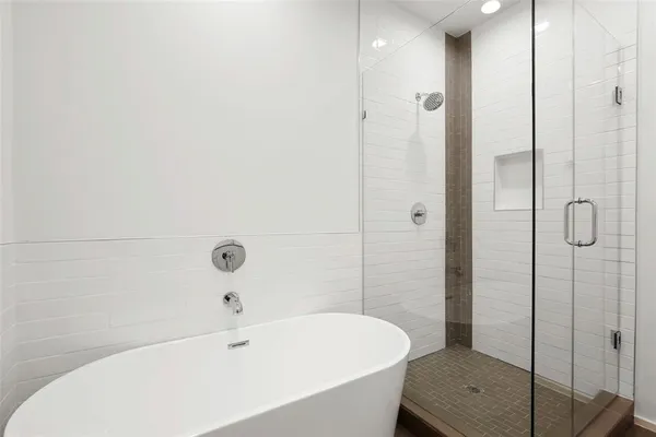 a bathroom with a bathtub and shower