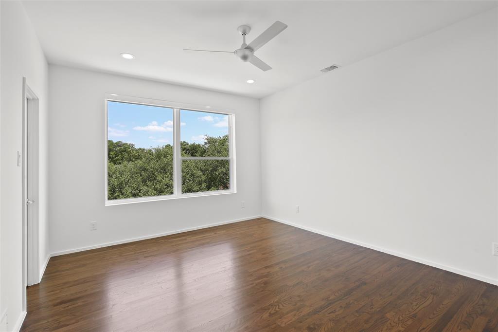 6250 Oram Street, Unit 102 Dallas, TX 75214 - Photo 14 of 21 an empty room with wooden floor and windows