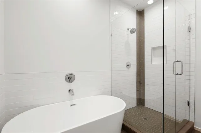 a bathroom with a bathtub and shower