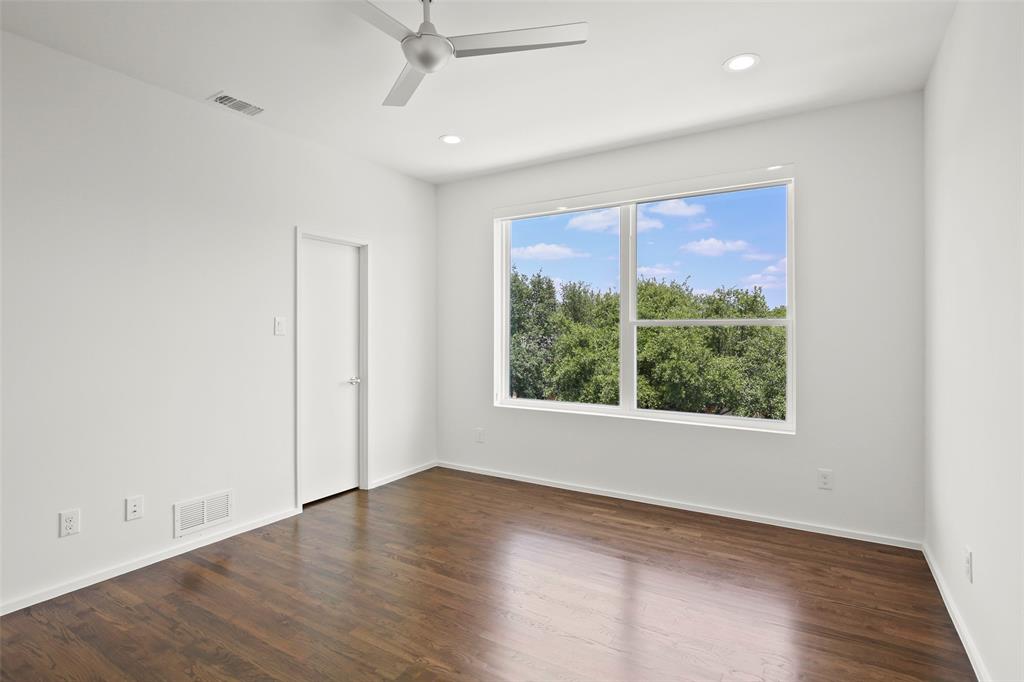 6250 Oram Street, Unit 102 Dallas, TX 75214 - Photo 18 of 21 an empty room with wooden floor and windows