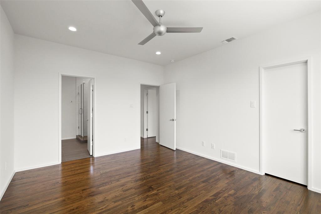 6250 Oram Street, Unit 102 Dallas, TX 75214 - Photo 19 of 21 an empty room with wooden floor and ceiling fan