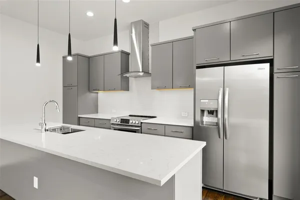 a kitchen with stainless steel appliances a refrigerator and a sink